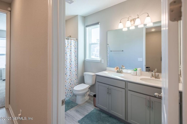 bathroom featuring vanity, hardwood / wood-style floors, a shower with curtain, and toilet