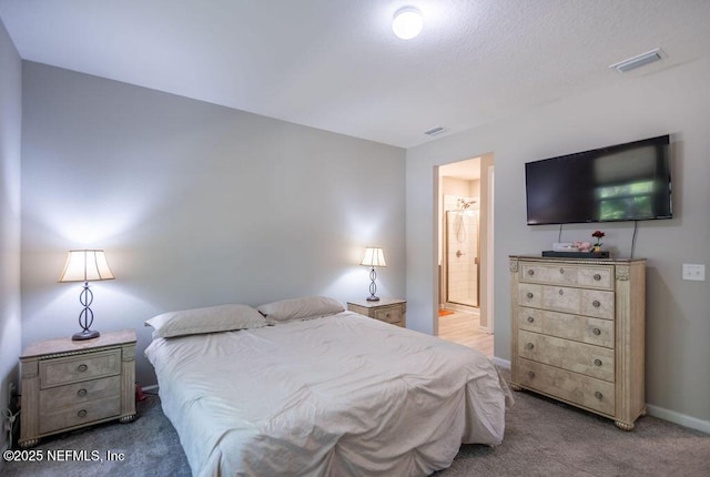 carpeted bedroom with connected bathroom