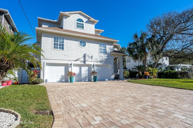 view of front of property featuring a garage and a front yard