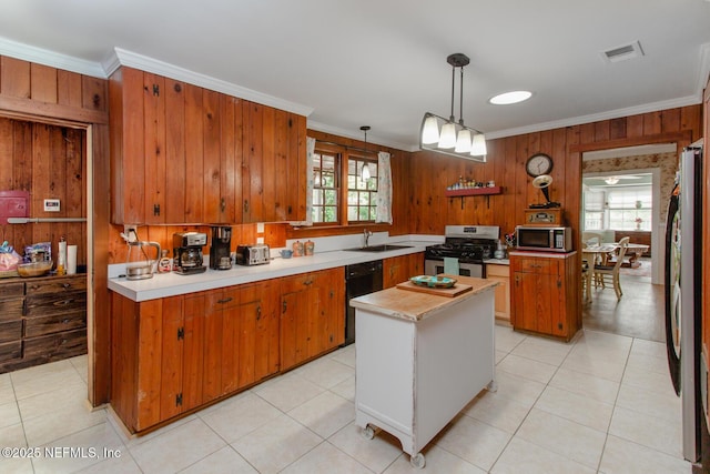 kitchen featuring decorative light fixtures, a center island, sink, crown molding, and stainless steel appliances