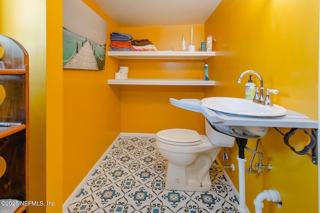 bathroom with tile patterned floors and toilet