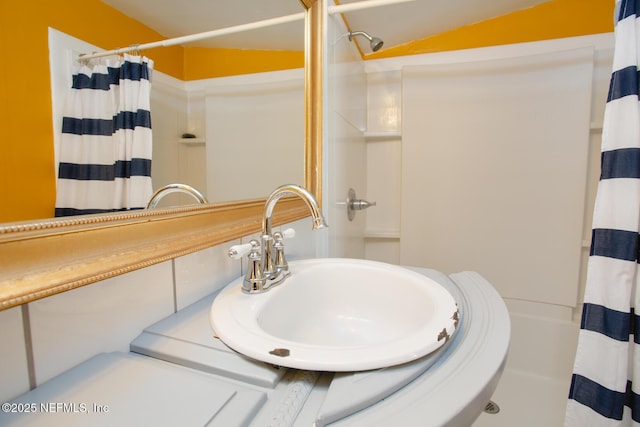 bathroom with a shower with shower curtain and sink