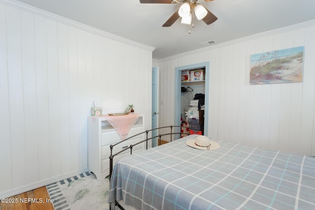 bedroom featuring ceiling fan, wood-type flooring, and crown molding