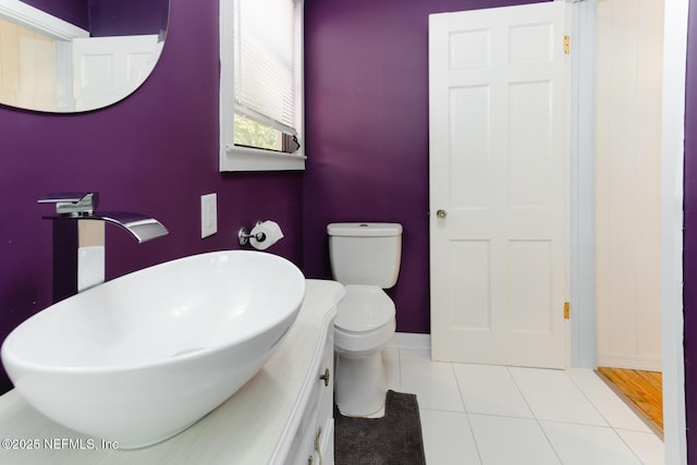 bathroom featuring toilet, tile patterned flooring, and sink