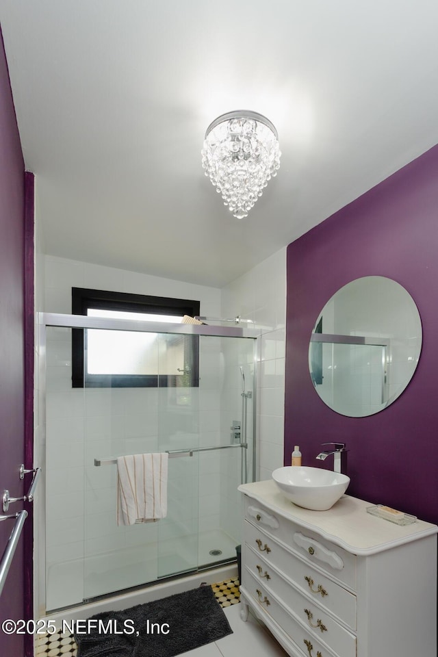 bathroom featuring an enclosed shower, tile patterned floors, vanity, and a chandelier