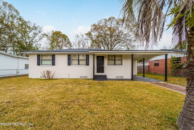 view of front of house with a front yard and a carport