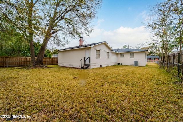 back of house featuring a yard and cooling unit