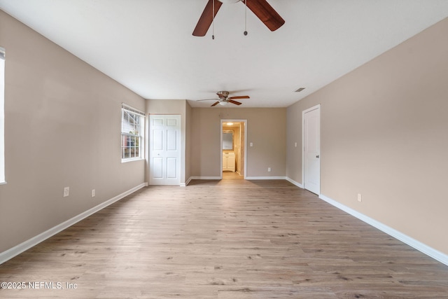 spare room with ceiling fan and light wood-type flooring