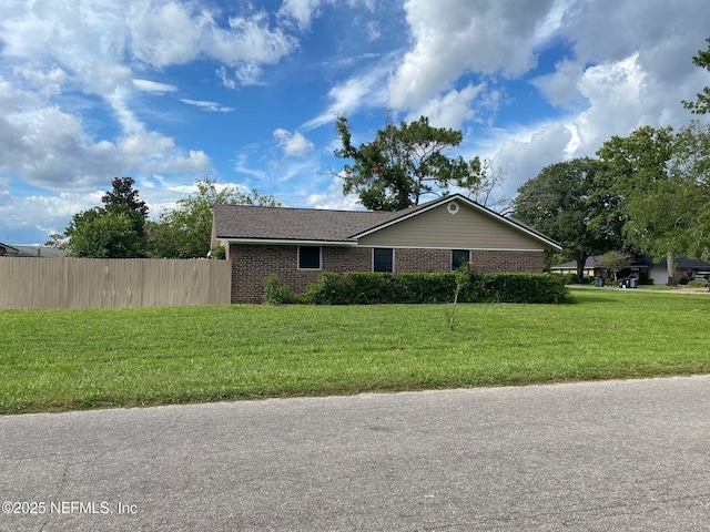 view of side of property with a yard