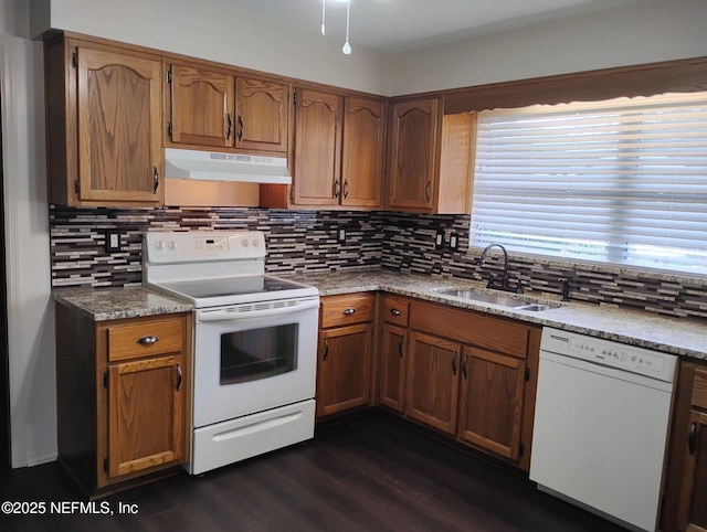 kitchen with white appliances, dark hardwood / wood-style floors, sink, and decorative backsplash