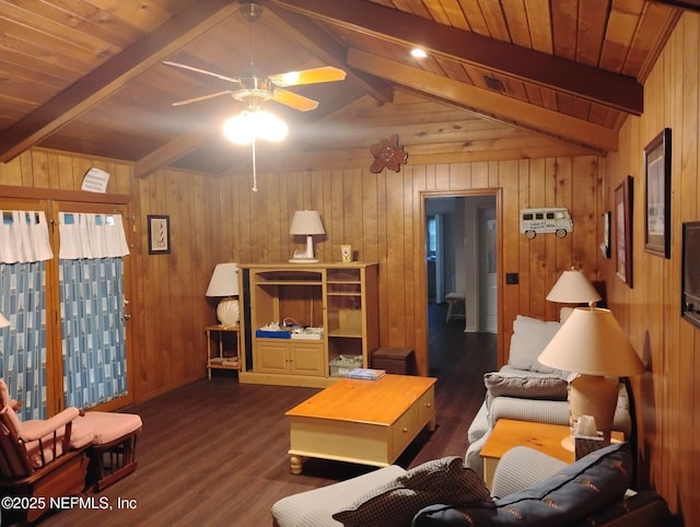 living room with lofted ceiling with beams, dark hardwood / wood-style floors, ceiling fan, and wood walls