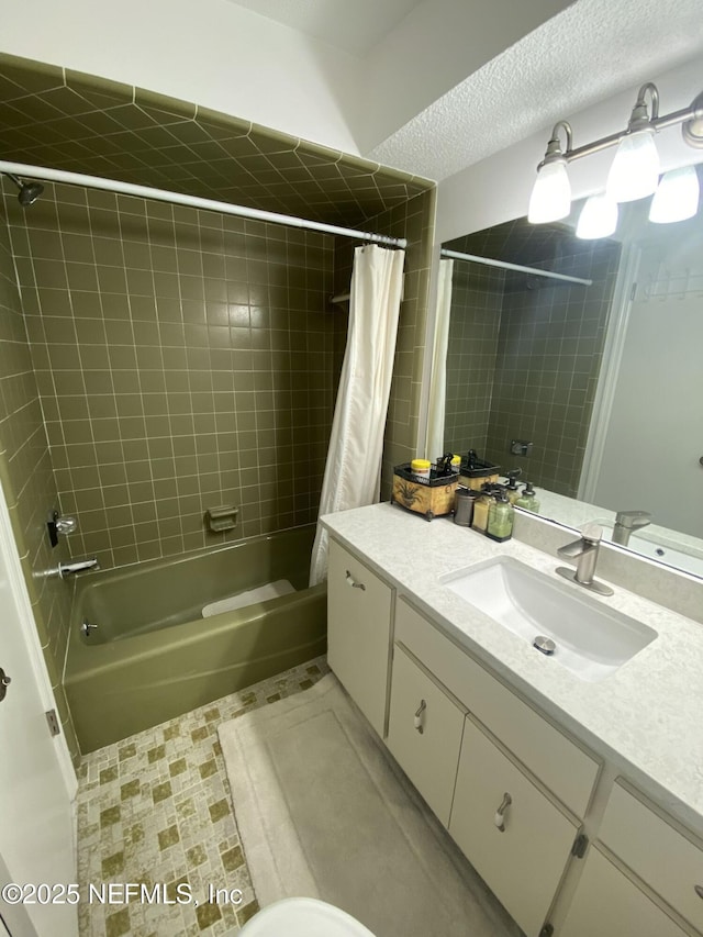 bathroom featuring vanity, shower / bathtub combination with curtain, tile patterned flooring, and a textured ceiling