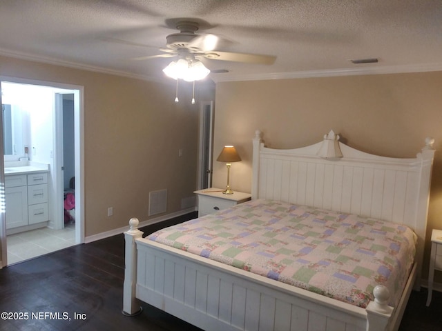 bedroom with connected bathroom, ornamental molding, dark hardwood / wood-style floors, and ceiling fan