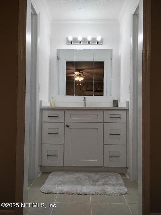 bathroom with vanity, crown molding, tile patterned floors, and ceiling fan