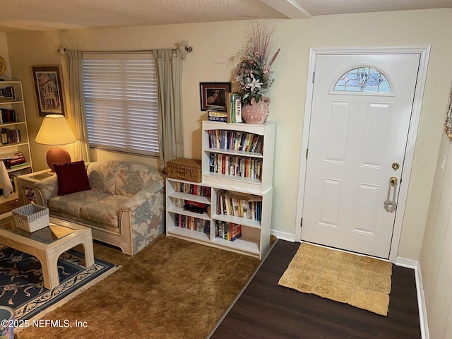 entryway featuring dark hardwood / wood-style floors and a textured ceiling