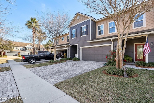 multi unit property featuring a garage and a front yard