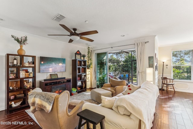 living room featuring crown molding, ceiling fan, and wood-type flooring