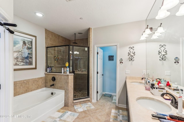 bathroom with vanity, plus walk in shower, tile patterned flooring, and a textured ceiling