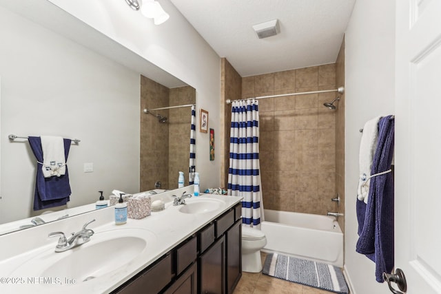 full bathroom featuring tile patterned floors, toilet, shower / bath combo with shower curtain, and vanity