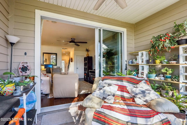 sunroom featuring ceiling fan