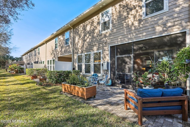 back of house with an outdoor hangout area, a yard, and a patio area