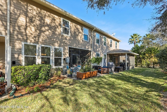 rear view of property featuring a lawn