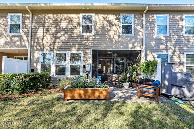 back of house featuring a yard and a patio area