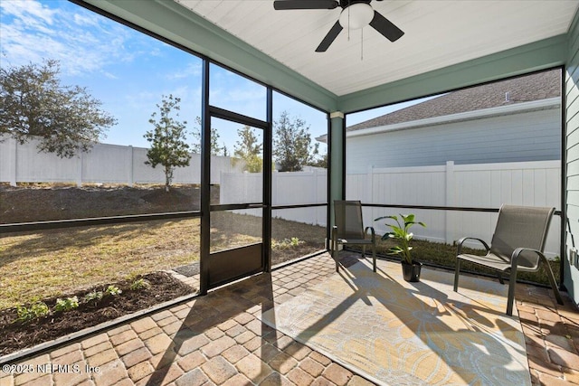 sunroom / solarium featuring ceiling fan and plenty of natural light