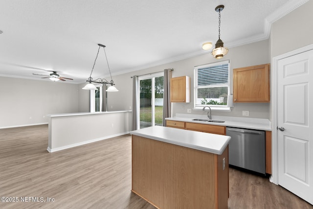 kitchen featuring stainless steel dishwasher, decorative light fixtures, a center island, and sink