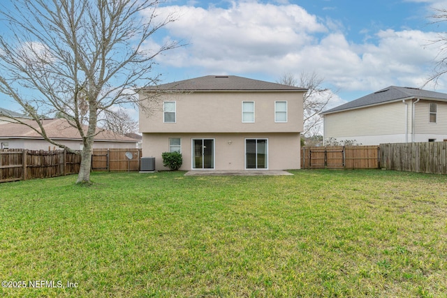 back of house with central AC unit, a lawn, and a patio