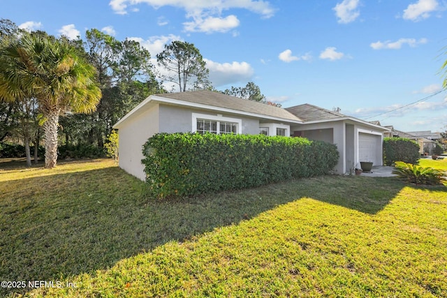 view of front of house with a front lawn and a garage