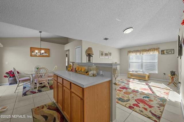 kitchen featuring light tile patterned floors, pendant lighting, and a center island