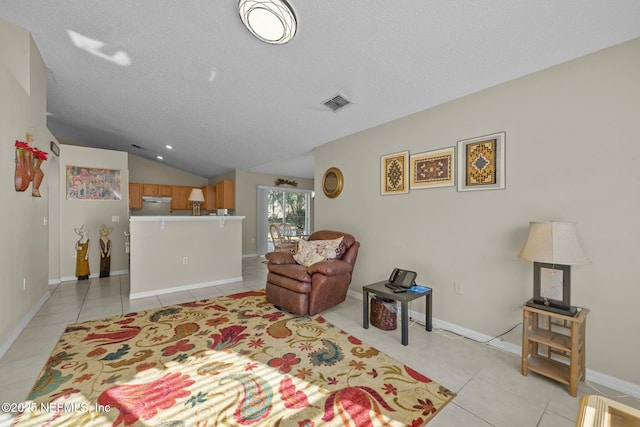 interior space with vaulted ceiling and a textured ceiling