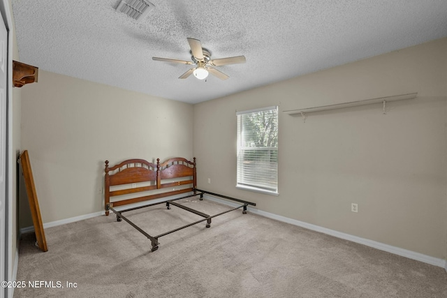 carpeted bedroom featuring a textured ceiling, ceiling fan, and a closet