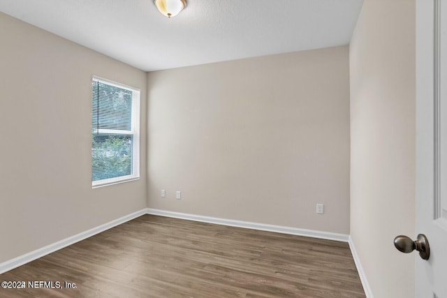 spare room with dark wood-type flooring