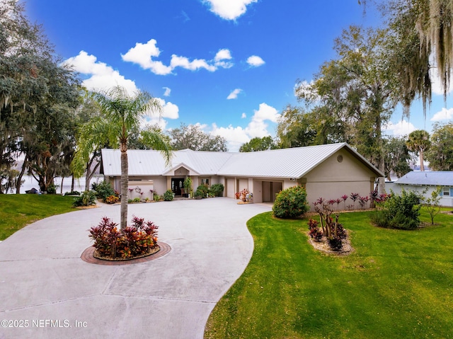 ranch-style home with a garage and a front yard