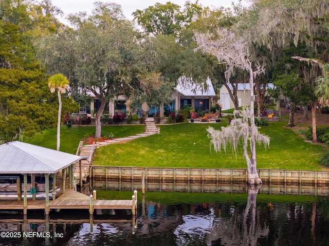 exterior space with a water view and a lawn