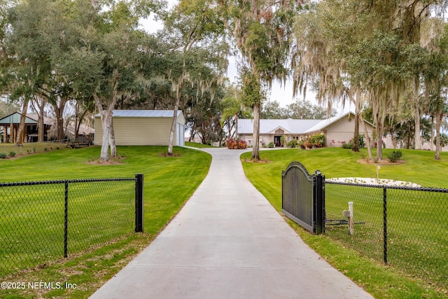 view of front of home with a front yard and an outbuilding