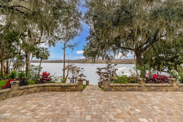 view of patio with a water view