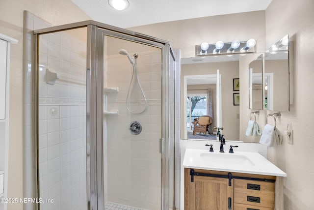 bathroom with a shower with door and vanity