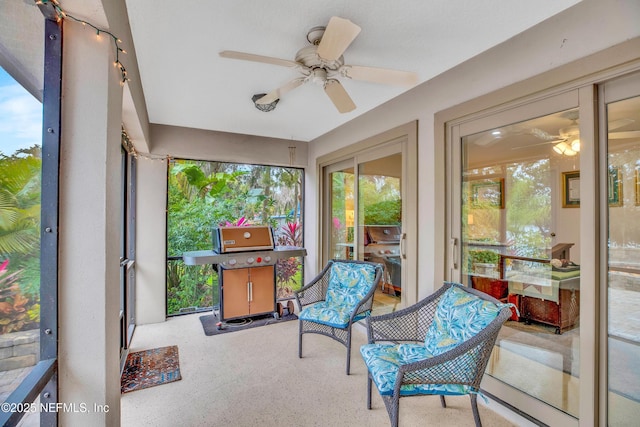 sunroom featuring ceiling fan