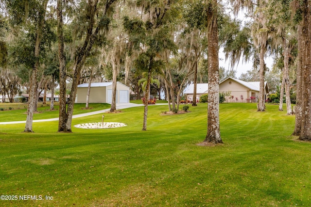 view of yard with a garage and an outdoor structure