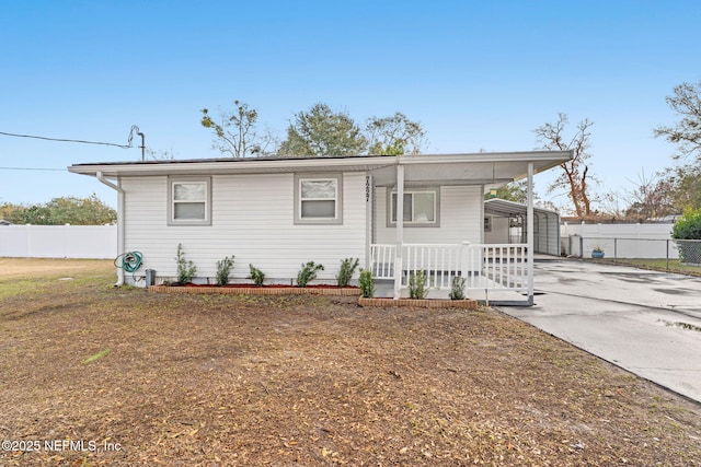 view of front of home featuring a carport and covered porch