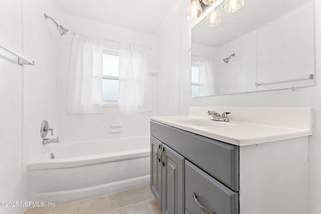 bathroom featuring tasteful backsplash, vanity, tile walls, tile patterned floors, and tiled shower / bath combo