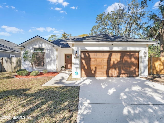 single story home featuring a garage and a front yard