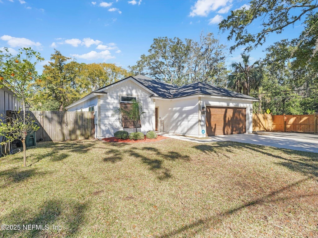 ranch-style home featuring a garage and a front lawn