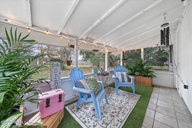 sunroom with beamed ceiling