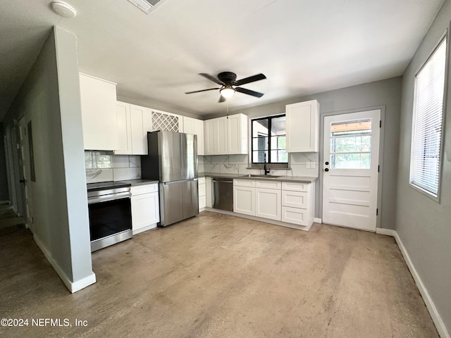 kitchen with ceiling fan, white cabinets, decorative backsplash, and appliances with stainless steel finishes