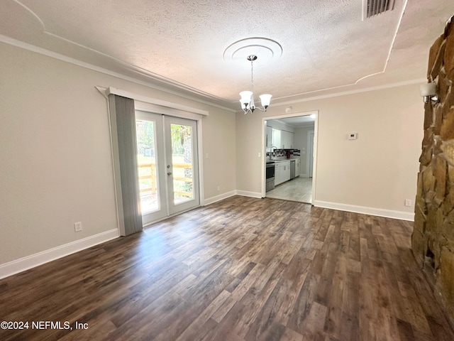 unfurnished room with french doors, dark hardwood / wood-style flooring, a textured ceiling, and a chandelier