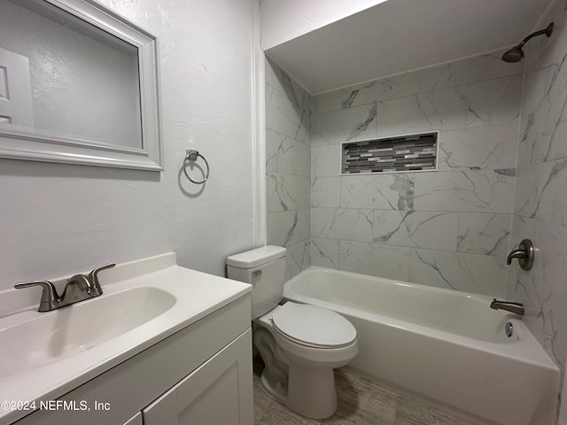 full bathroom with toilet, tiled shower / bath, and vanity